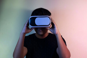 A man wearing virtual reality glasses touches video and new technology.