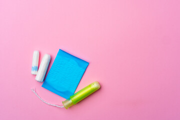 Female hygienic pad and tampons on pink background