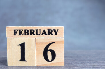 Day 16 of february month, Wooden calendar with date. Empty space for text.