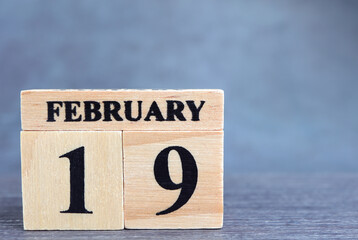 Day 19 of february month, Wooden calendar with date. Empty space for text.