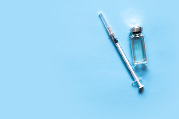 Medicine vial and syringe. Vacctination session against coronavirus Covid-19 and immunity improvement. Flat lay