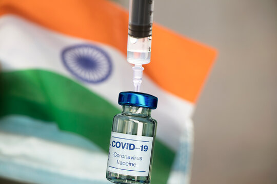 Covid-19 vaccine with syringe and indian flag in the background-selective focus