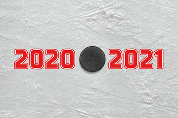 Fragment of the ice rink with a red inscription and a hockey puck