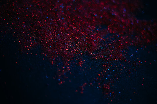 Red Sand From Sequins. Scattered Sparkles On A Black Background. Space Texture. Stars