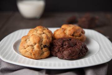 Cookies on a wooden table with a glass of milk
