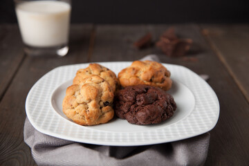 Cookies on a wooden table with a glass of milk
