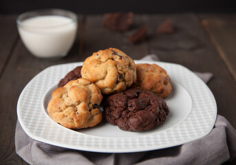 Cookies on a wooden table with a glass of milk