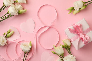 8 made of ribbon, roses, hearts and gift box on pink background, top view