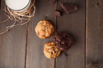 Cookies on a wooden table with a glass of milk