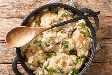 Chicken in White Wine Hong am Reisleck Luxembourg recipe closeup in the pan on the table. horizontal top view from above