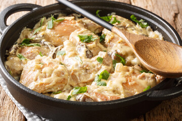 Chicken in White Wine Hong am Reisleck Luxembourg recipe closeup in the pan on the table. horizontal