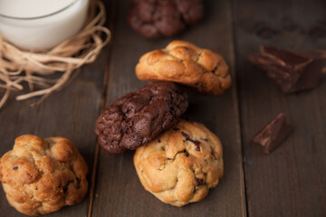 Cookies on a wooden table with a glass of milk