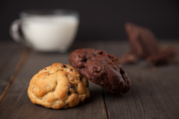 Cookies on a wooden table with a glass of milk