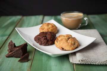 Cookies on a white plate with coffee latte
