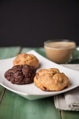 Cookies on a white plate with coffee latte
