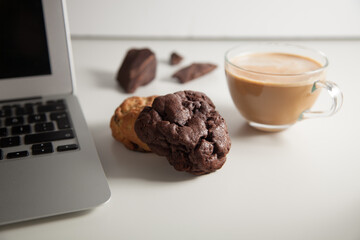 Cookies with a laptop and a glass of coffee latte