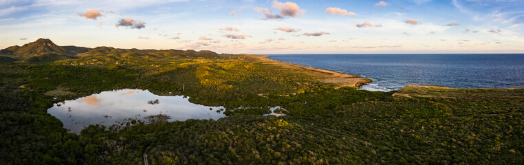 Aerial view above scenery of Curacao, Caribbean with ocean, coast, hills, lake