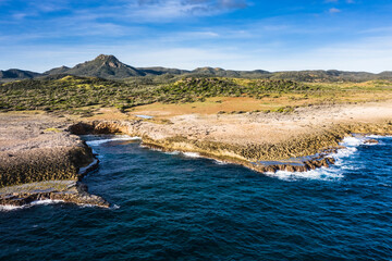 Aerial view above scenery of Curacao, Caribbean with ocean, coast, hills, lake