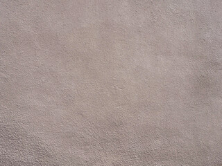 Fototapeta na wymiar Wall with beige pink grainy plaster. Texture not seamless. Full screen photo