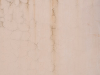 Pink wall with streaks of cracks and dark smudges. Texture not seamless
