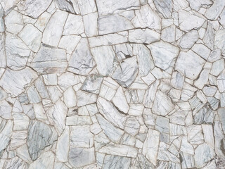 Wall clad in gray textured granite spotty shards of different sizes. Texture not seamless