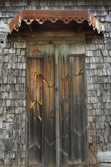 old wooden door with rusty intricate overhang in the old house on the tropical island of La Réunion, France