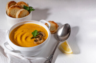 Red lentil soup (Turkish: Mercimek Çorbası ) on white table. Traditional middle eastern, turkish , ramadan cuisine. The concept of healthy and vegetarian food. Top view