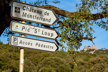 Signs at the entrance at the of the Chateau de Montferrand and the hiking trail of the pic st loup.