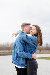 Fototapeta premium Young loving couple embracing each other outdoors in the park
