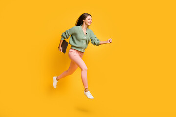 Fototapeta na wymiar Full size profile side photo of young pretty happy business woman run in air with laptop in hand isolated on yellow color background