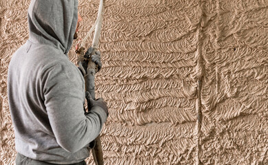 Man with plastering pump. Walls with gypsum plaster or cement plaster. Plasterer operating sprayer...