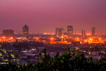 The high angle background of the city view with the secret light of the evening, blurring of night lights, showing the distribution of condominiums, dense homes in the capital community