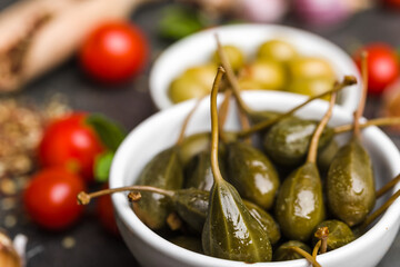 Capers. Marinated cooking ingredients. Mediterranean food background.