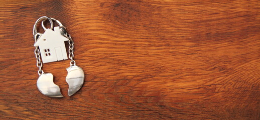 a house with a broken heart on a wooden plank symbolizing divorce 