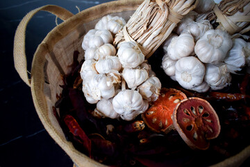 Garlic in organic bag on the table in kitchen room.