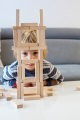 Toddler child, playing with wooden puzzle