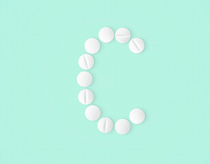 letter C made of vitamin pills