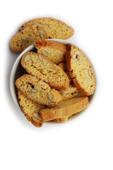 Traditional Italian Cantucci or Cantuccini cookies with almonds in a bowl isolated on white background