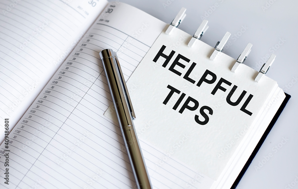 Poster helpful tips text written on a notebook with pen