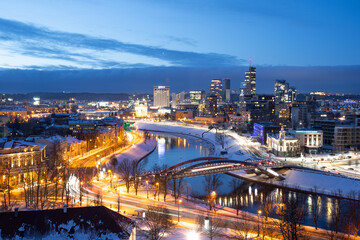 Obraz premium Vilnius, capital of Lithuania, beautiful scenic aerial panorama of modern business financial district architecture buildings with river and bridge in winter