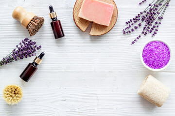 Fototapeta na wymiar Frame of lavender bath salt and essential oil, top view