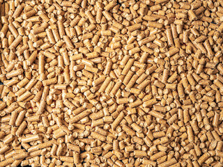 Natural wooden pellets background as renewable energy. Close-up wood pellet pattern. Top view. Flat lay.