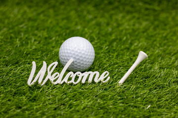 Welcome sign is on green grass for golfer