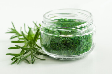Glass jar with green rosemary bath salts (foot soak).