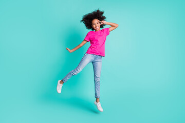 Fototapeta na wymiar Full size photo of young pretty sweet charming lovely happy girl jump show v-sign on eye isolated on teal color background