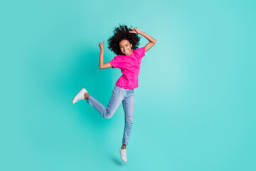 Fototapeta na wymiar Full size photo of young happy positive smiling cheerful girl jump showing v-sign isolated on turquoise color background