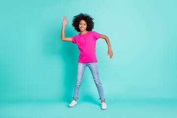 Full length photo portrait of black skin girl doing robot dance moves isolated on vivid cyan colored background