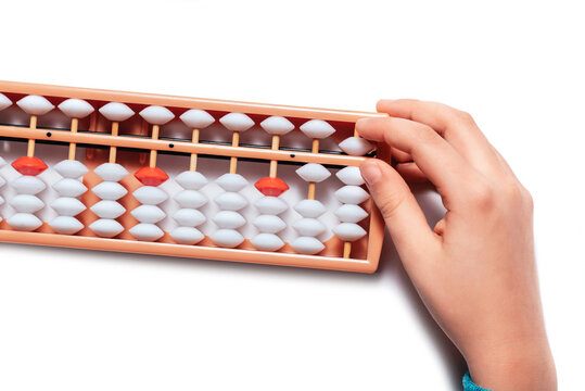 Japanese traditional abacus soroban isolated on white background. Child Hand using abacus. Education and development concept. Back to school, math education, mental mathematics, arithmetic
