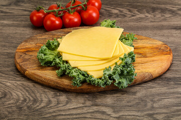 Sliced Gauda cheese over board