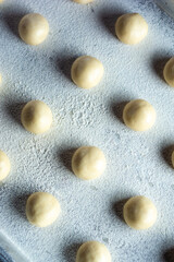 pattern of donnut dough on bake sheet with white flour